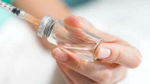 Macro image of nurse preparing medication in glass ampule Stock Photos