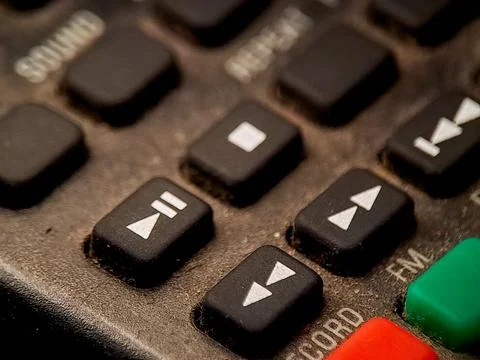 Macro image showing the buttons on an older electronic device with aged, te.. Stock Photos