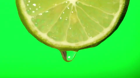 Macro image of water droplets falling from lemon slices on green background. Stock Footage 227859657