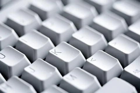 Macro image of white buttons of computer keypad with letters and symbols on them Stock Photos