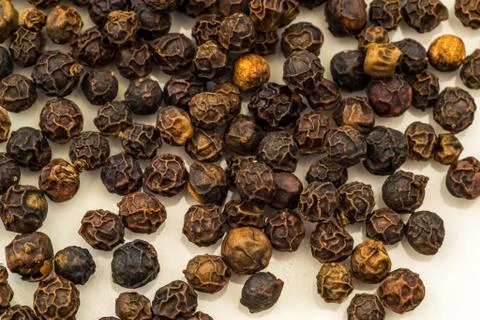 Macro Image of Whole Black Peppercorns Stock Photos