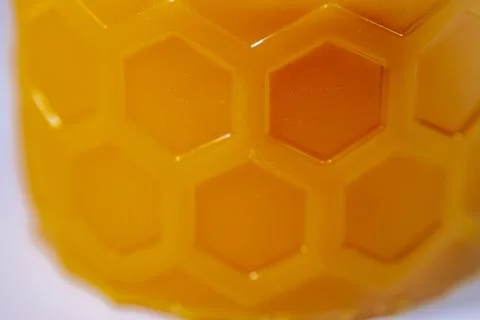 Macro image of a yellow surface with embossed hexagonal. Stock Photos