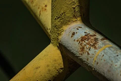 Macro of industrial iron pipe joint rust texture steel structure at night Фото