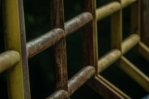 Macro of industrial iron railing grid pattern rust texture at night Stock Photos