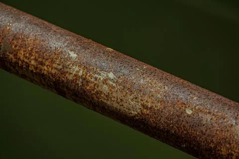 Macro of industrial rust texture on iron railing steel pipe at night Stock Photos