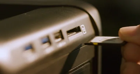Macro inserting a memory card into a computer 스톡 동영상 115516149