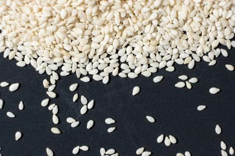 Macro kernels of white roasted sesame seeds. Stock Photos