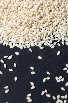 Macro kernels of white roasted sesame seeds. Stock Photos