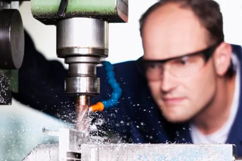 Macro of laborer at milling machine. Stock Photos