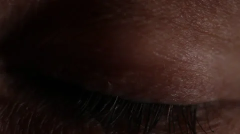 Macro of lashes on closed eyelid twitching in darkness. HD 1080p 24fps. Stock Footage 22734228