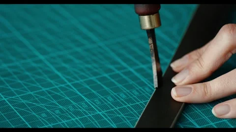 Macro. Leather handbag craftsman at work in a workshop. Woman's hands holding cr Video stock 297084154