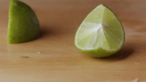 Macro lemon being sliced and dropped slow motion knife lime cutting Stock Footage 274313338