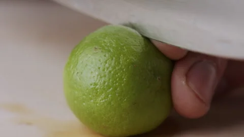 Macro lemon being sliced and dropped slow motion knife lime cutting Stock Footage 274313339