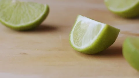 Macro lemon being sliced and dropped slow motion knife lime cutting Stock Footage 274313365