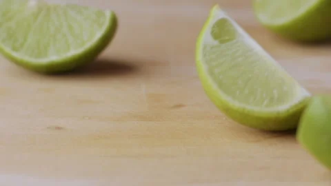 Macro lemon being sliced and dropped slow motion knife lime cutting Stock Footage 274313375