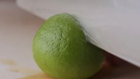 Macro lemon being sliced and dropped slow motion knife lime cutting Stock Footage 274313394