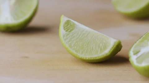 Macro lemon being sliced and dropped slow motion knife lime cutting Video stock 274313415