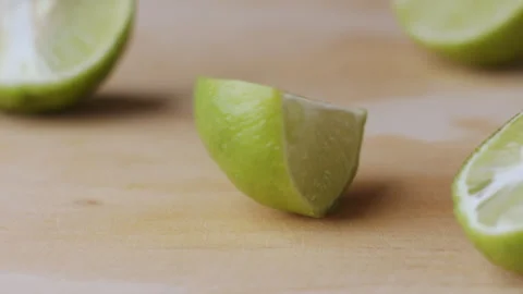 Macro lemon being sliced and dropped slow motion knife lime cutting Stock Footage 274313421