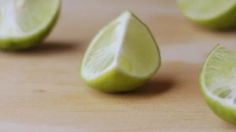Macro lemon being sliced and dropped slow motion knife lime cutting Stock Footage 274313444
