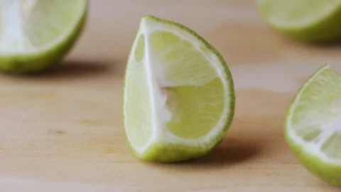 Macro lemon being sliced and dropped slow motion knife lime cutting Stock Footage 274313449