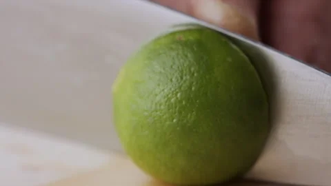 Macro lemon being sliced and dropped slow motion knife lime cutting Stock Footage 274313452