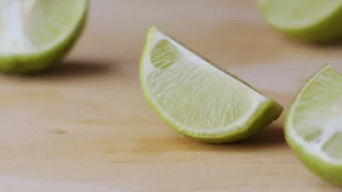Macro lemon being sliced and dropped slow motion knife lime cutting Stock Footage 274313469