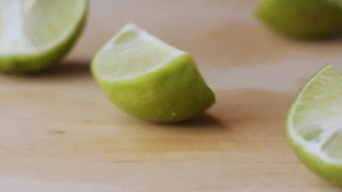 Macro lemon being sliced and dropped slow motion knife lime cutting Stock Footage 274313470