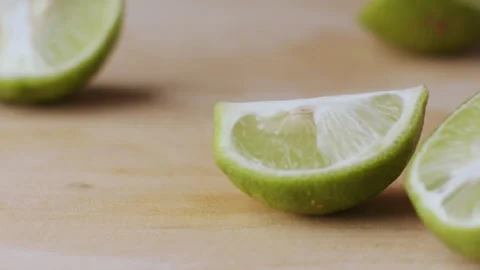 Macro lemon being sliced and dropped slow motion knife lime cutting Video stock 274313487