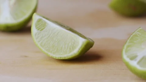Macro lemon being sliced and dropped slow motion knife lime cutting Stock Footage 274313491