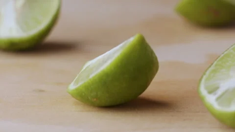 Macro lemon being sliced and dropped slow motion knife lime cutting Stock Footage 274313721
