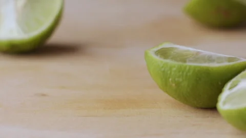 Macro lemon being sliced and dropped slow motion knife lime cutting Stock Footage 274314262