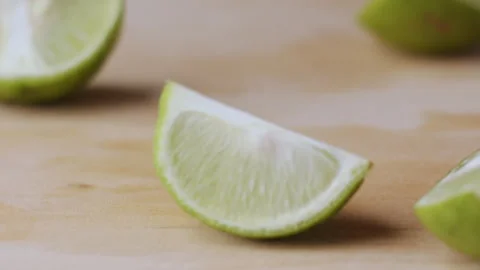 Macro lemon being sliced and dropped slow motion knife lime cutting Video stock 274314875
