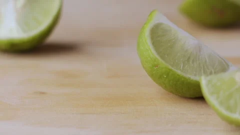 Macro lemon being sliced and dropped slow motion knife lime cutting Stock Footage 274314950