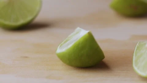 Macro lemon being sliced and dropped slow motion knife lime cutting Stock Footage 274315016