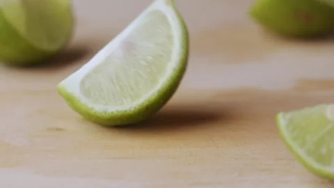 Macro lemon being sliced and dropped slow motion knife lime cutting Stock Footage 274315030