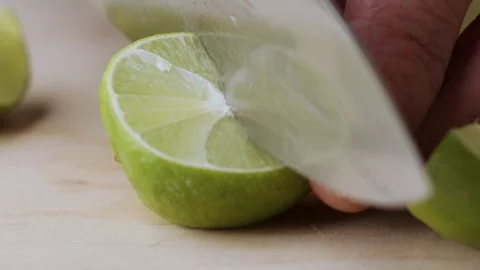Macro lemon being sliced and dropped slow motion knife lime cutting Stock Footage 274315210