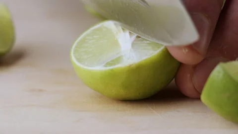 Macro lemon being sliced and dropped slow motion knife lime cutting Stock Footage 274315269