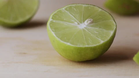 Macro lemon being sliced and dropped slow motion knife lime cutting Stock Footage 274315477