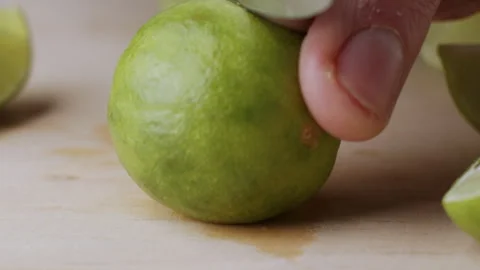 Macro lemon being sliced and dropped slow motion knife lime cutting Stock Footage 274315513