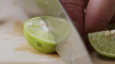 Macro lemon being sliced and dropped slow motion knife lime cutting Video stock 274315534