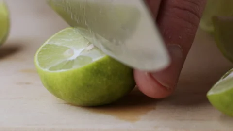 Macro lemon being sliced and dropped slow motion knife lime cutting Video stock 274315547