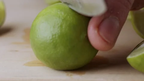 Macro lemon being sliced and dropped slow motion knife lime cutting Stock Footage 274315695