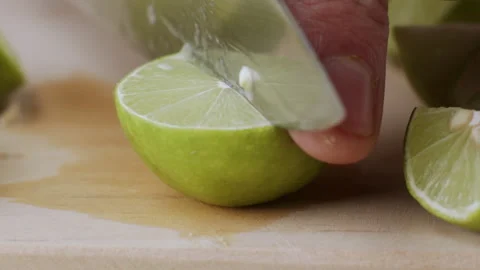 Macro lemon being sliced and dropped slow motion knife lime cutting Stock Footage 274315756