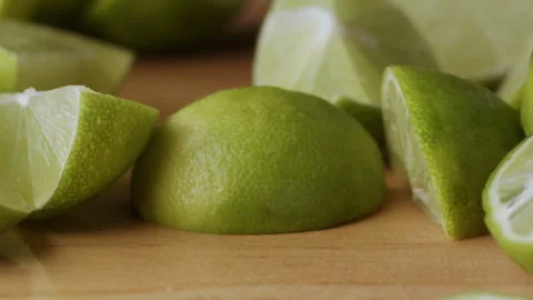 Macro lemon being sliced and dropped slow motion knife lime cutting Stock Footage 274316187