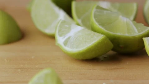 Macro lemon being sliced and dropped slow motion knife lime cutting Stock Footage 274316341