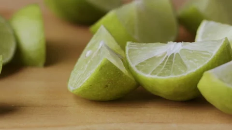 Macro lemon being sliced and dropped slow motion knife lime cutting Stock Footage 274316354