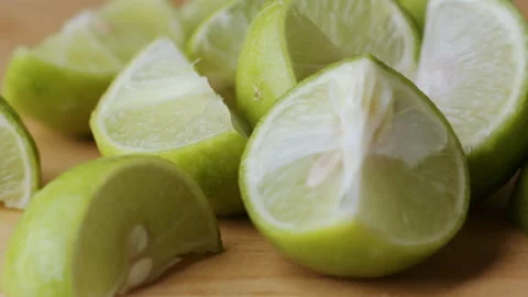 Macro lemon being sliced and dropped slow motion knife lime cutting Stock Footage 274316361