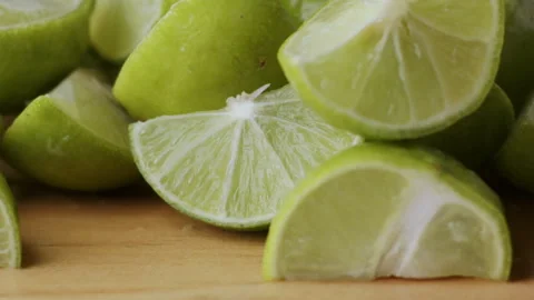 Macro lemon being sliced and dropped slow motion knife lime cutting Stock Footage 274316393