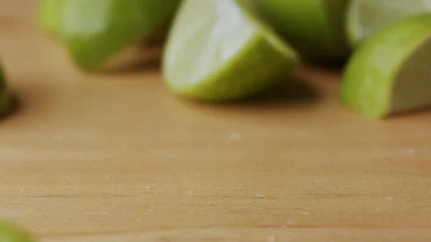 Macro lemon being sliced and dropped slow motion knife lime cutting Stock Footage 274316406