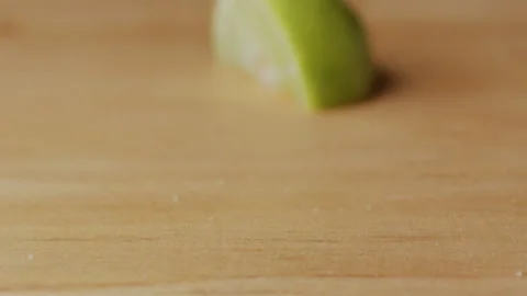 Macro lemon being sliced and dropped slow motion knife lime cutting Stock Footage 274316426